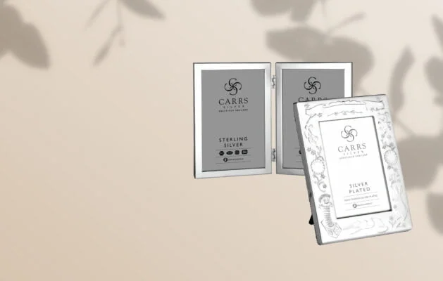 a selection of silver photo frames on a neutral background
