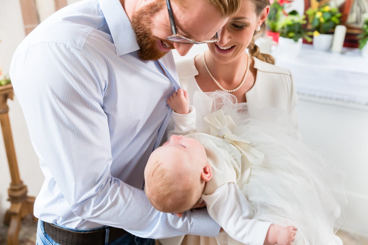 parents with baby at christening