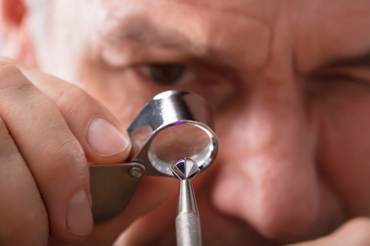 Person Checking Quality Of Diamond
