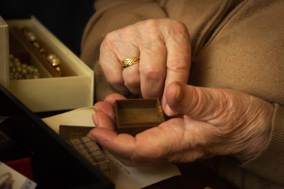 senior lady handling jewellery from jewellery box